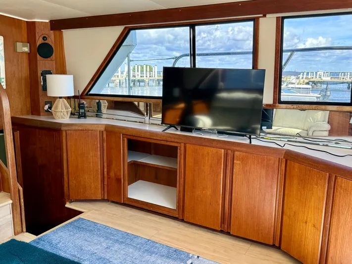 Journey's End Yacht Photos Pics Interior of a 1989 Californian 48MY yacht with wooden cabinets and TV.