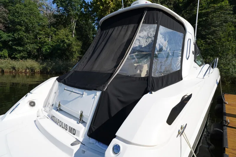  Yacht Photos Pics 2010 Sea Ray 370 Sundancer docked near lush greenery.