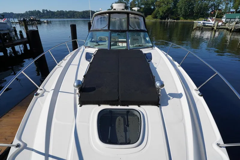  Yacht Photos Pics 2010 Sea Ray 370 Sundancer yacht docked by a serene waterfront.