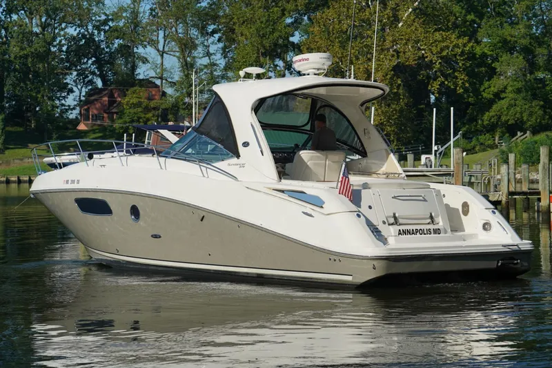  Yacht Photos Pics 2010 Sea Ray 370 Sundancer yacht docked in Annapolis, MD, surrounded by lush greenery.