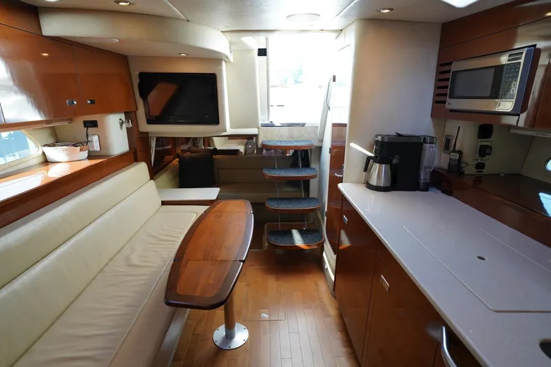  Yacht Photos Pics Luxurious interior of 2010 Sea Ray 370 Sundancer yacht with modern kitchen and seating area.