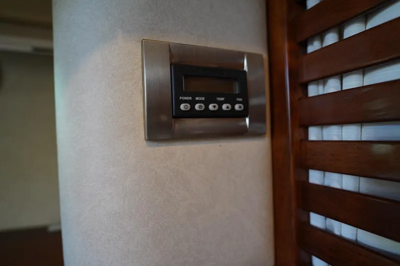  Yacht Photos Pics Thermostat control panel inside 2010 Sea Ray 370 Sundancer yacht, near wooden blinds.