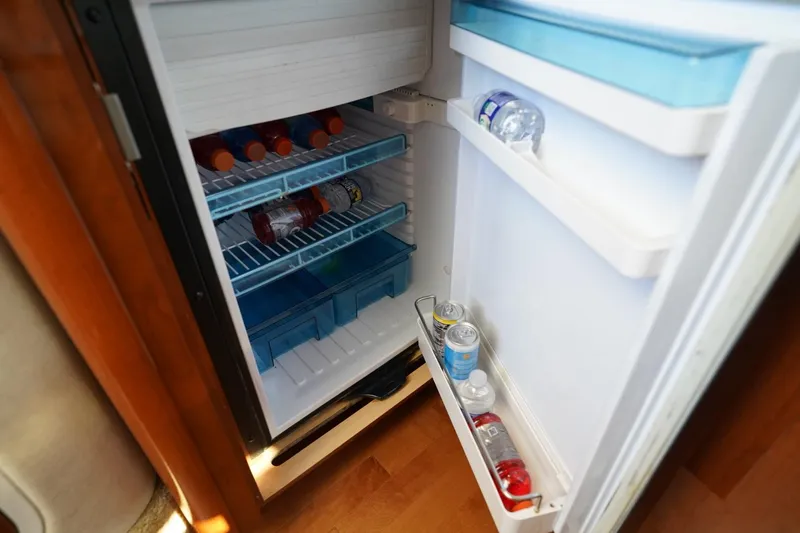  Yacht Photos Pics Open fridge on 2010 Sea Ray 370 Sundancer yacht, stocked with drinks and beverages.