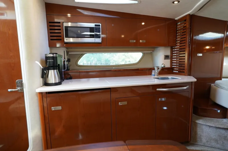  Yacht Photos Pics Luxurious 2010 Sea Ray 370 Sundancer yacht kitchen with modern amenities and sleek wood cabinetry.