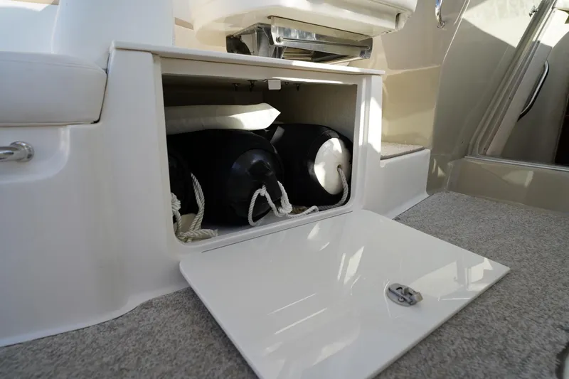  Yacht Photos Pics Open storage compartment on 2010 Sea Ray 370 Sundancer boat, showing fenders and ropes.