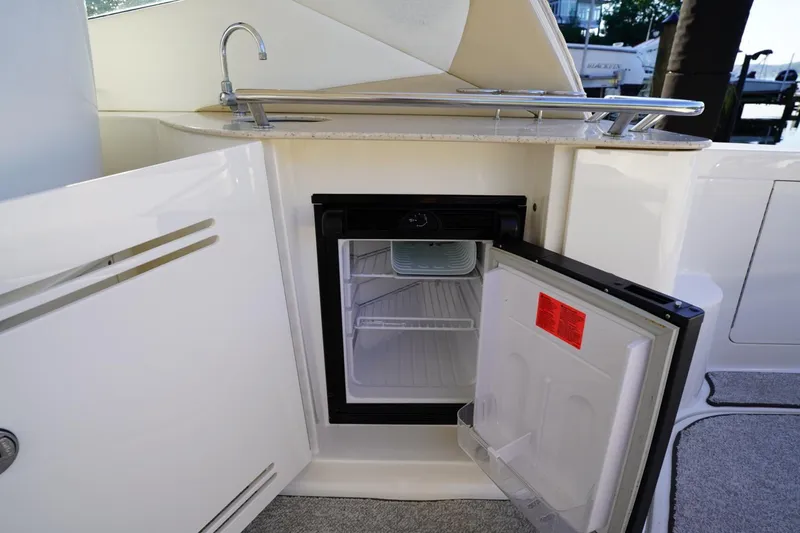  Yacht Photos Pics 2010 Sea Ray 370 Sundancer yacht kitchenette with open mini fridge and sink.