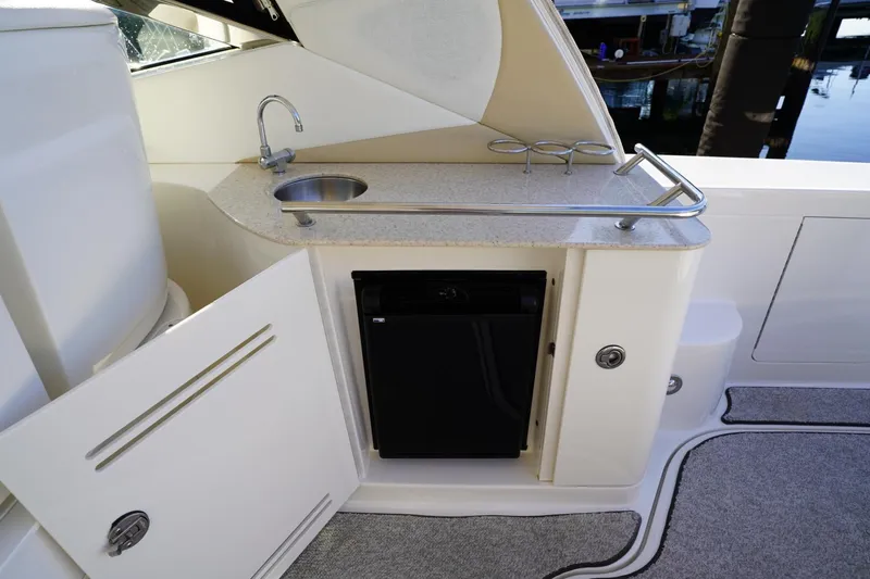  Yacht Photos Pics 2010 Sea Ray 370 Sundancer yacht kitchenette with sink, mini-fridge, and storage.