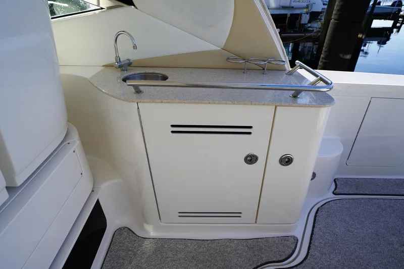  Yacht Photos Pics 2010 Sea Ray 370 Sundancer yacht kitchenette with sink and storage cabinets.