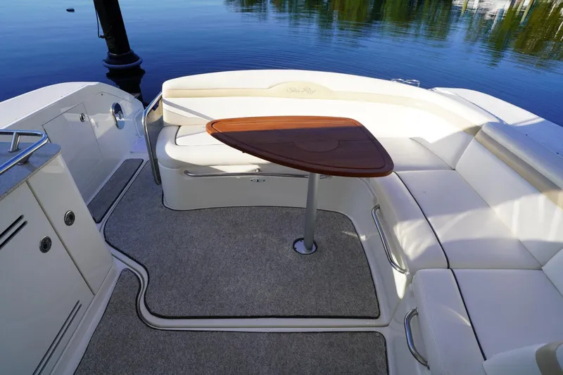 Yacht Photos Pics 2010 Sea Ray 370 Sundancer boat interior with seating and wooden table by the water.