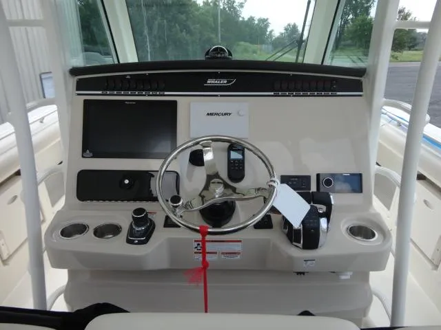  Yacht Photos Pics 2021 Boston Whaler 350 Outrage helm with steering wheel and navigation controls.