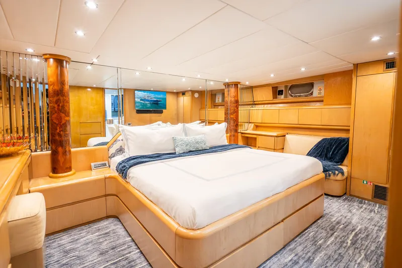 Azure Yacht Photos Pics Luxurious Maiora Planning 1991 yacht bedroom with elegant wood finishes and plush bedding.
