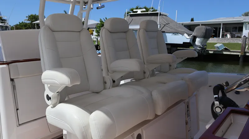  Yacht Photos Pics Luxurious seating on 2019 Everglades 435 Center Console boat, featuring plush white captain's chairs.