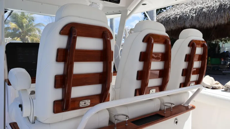  Yacht Photos Pics 2019 Everglades 435 Center Console boat seats with wooden accents and white upholstery.