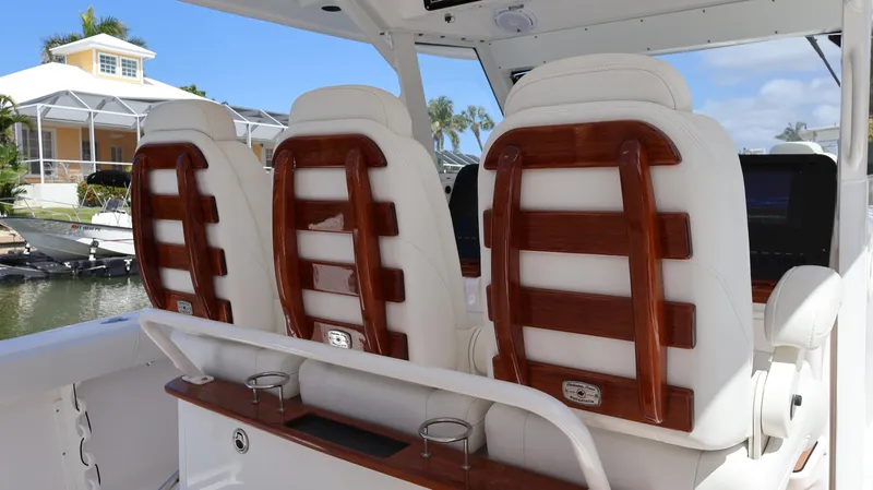  Yacht Photos Pics 2019 Everglades 435 Center Console boat with luxurious white and wood-accented seating.