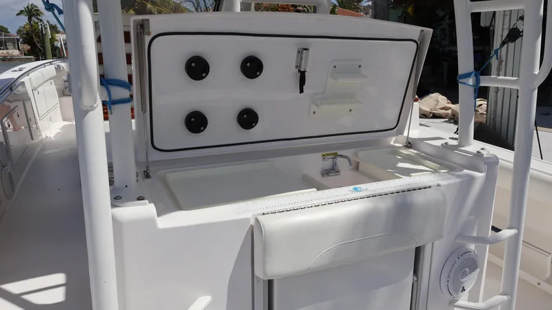  Yacht Photos Pics 2019 Everglades 435 Center Console boat interior with open storage compartment.