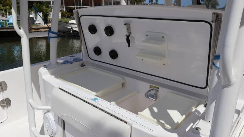  Yacht Photos Pics 2019 Everglades 435 Center Console boat with open storage compartments and control panel.