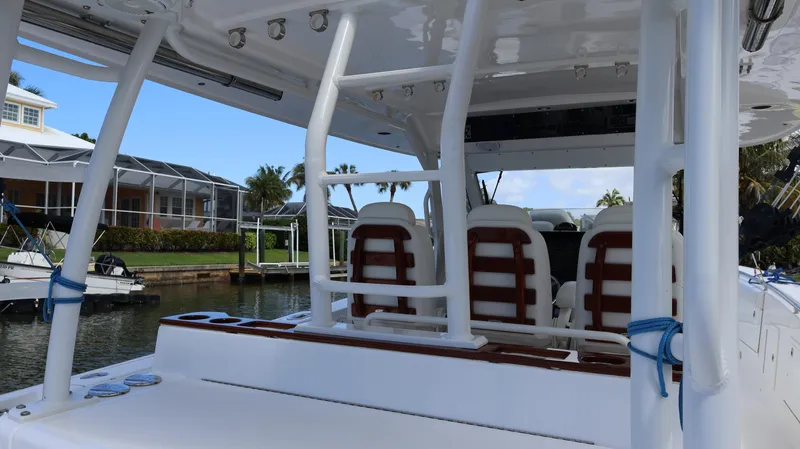  Yacht Photos Pics 2019 Everglades 435 Center Console boat interior with seating and helm, docked by waterfront homes.