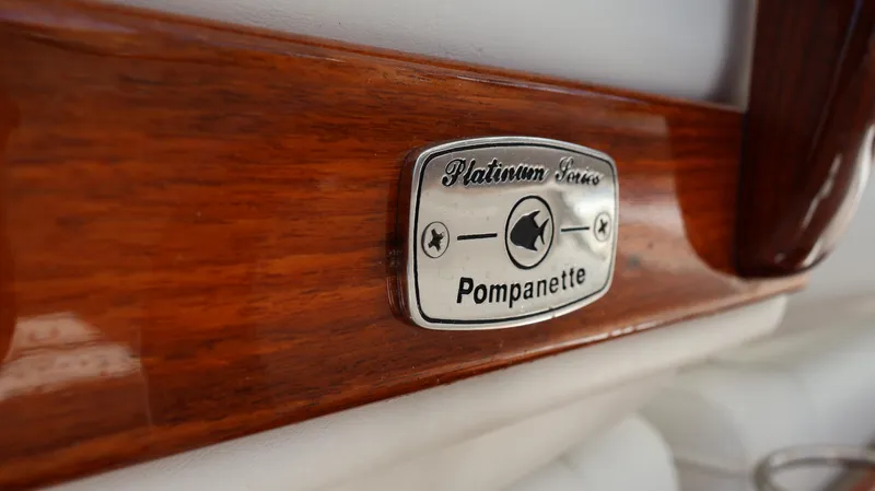  Yacht Photos Pics Pompanette Platinum Series badge on Everglades 435 Center Console, 2019 model, wooden finish.