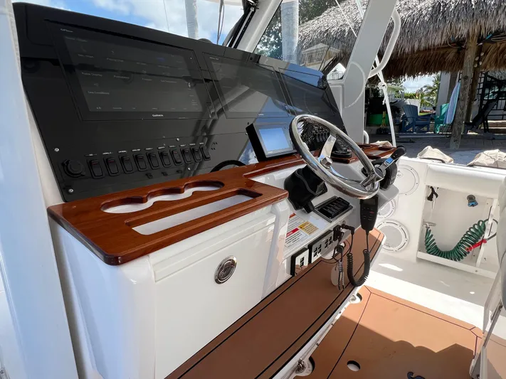  Yacht Photos Pics 2019 Everglades 435 Center Console boat dashboard with steering wheel and control panel.