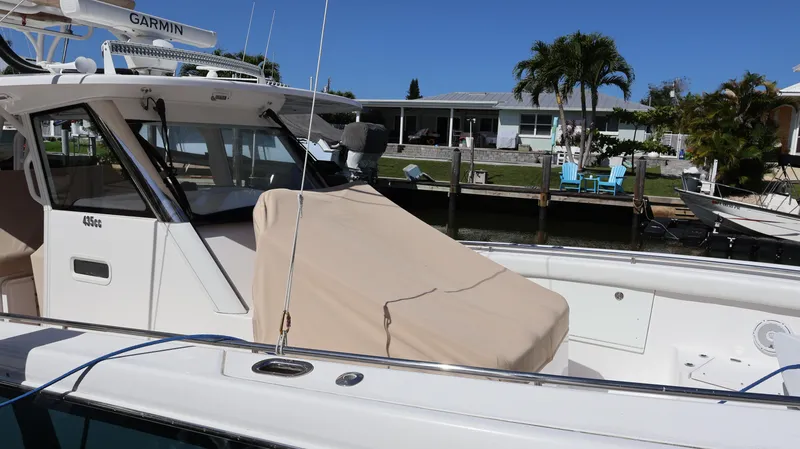  Yacht Photos Pics 2019 Everglades 435 Center Console boat docked near waterfront homes.