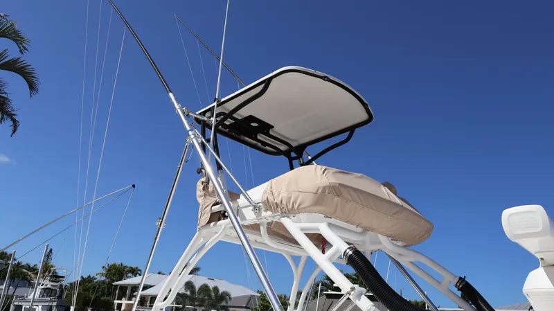  Yacht Photos Pics 2019 Everglades 435 Center Console boat with fishing rods against clear blue sky.