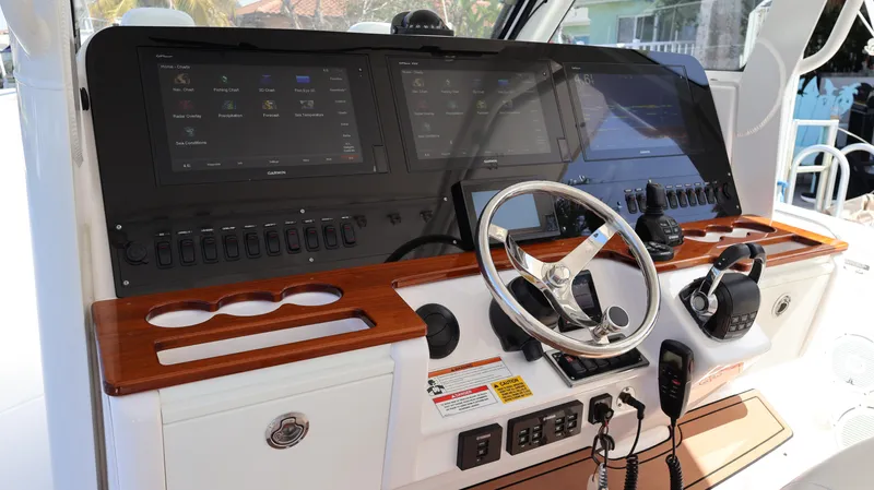  Yacht Photos Pics 2019 Everglades 435 Center Console boat dashboard with steering wheel and electronic controls.