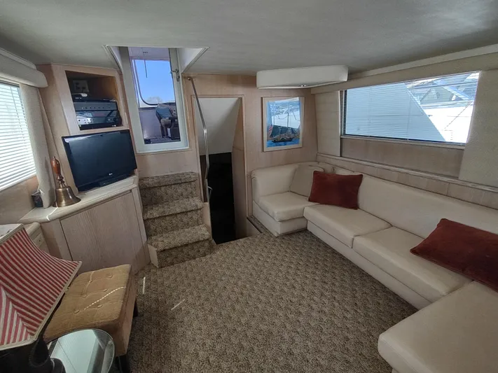  Yacht Photos Pics Interior of 1995 Hatteras 52 Cockpit Motor Yacht with beige seating and entertainment area.