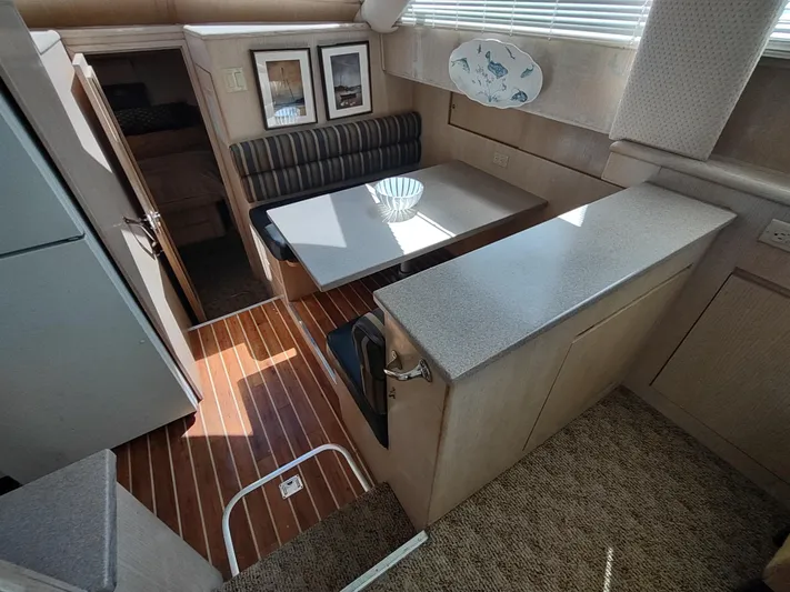  Yacht Photos Pics Interior of 1995 Hatteras 52 Cockpit Motor Yacht with dining area and wood flooring.