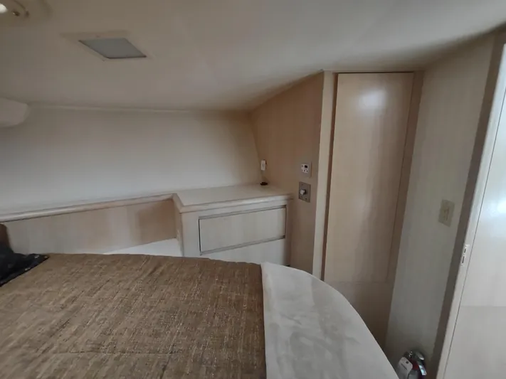  Yacht Photos Pics 1995 Hatteras 52 Cockpit Motor Yacht interior cabin with bed and storage.