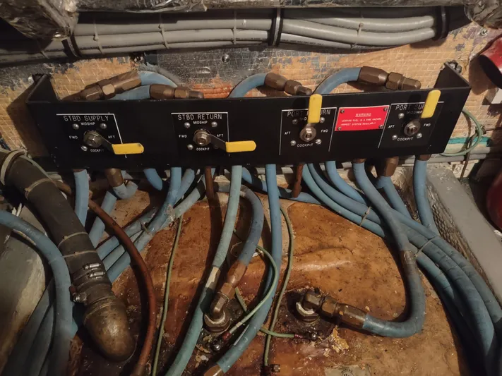  Yacht Photos Pics Engine room of 1995 Hatteras 52 Cockpit Motor Yacht with control panel and hoses.