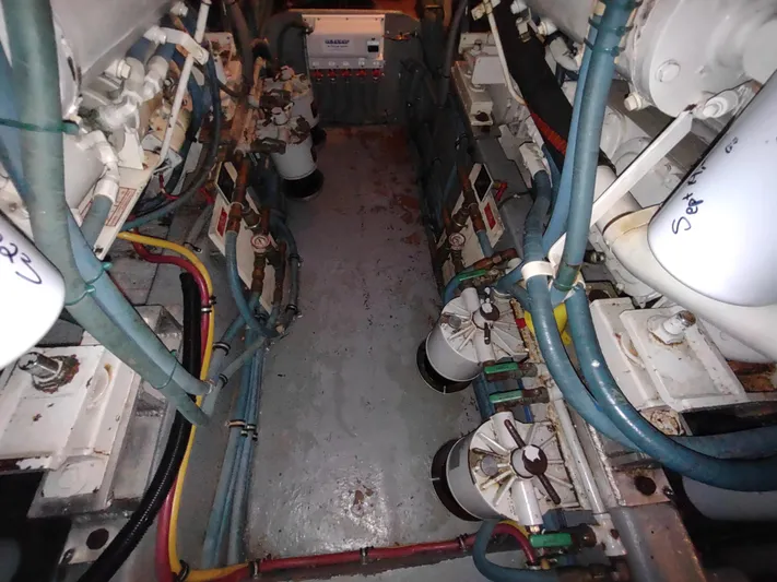  Yacht Photos Pics Engine room of 1995 Hatteras 52 Cockpit Motor Yacht with visible machinery and hoses.