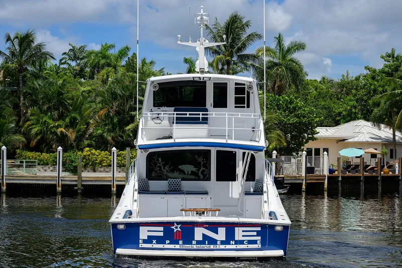  Yacht Photos Pics 2001 Viking 65 Enclosed Bridge yacht docked near tropical waterfront homes.