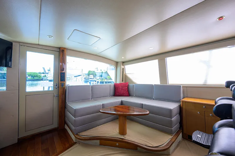  Yacht Photos Pics Interior of 2001 Viking 65 Enclosed Bridge yacht with modern seating and wooden accents.