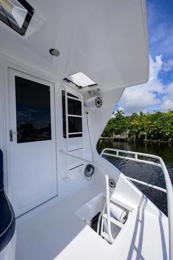  Yacht Photos Pics 2001 Viking 65 Enclosed Bridge yacht deck with white exterior and water view.