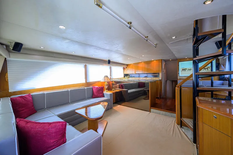  Yacht Photos Pics Luxurious interior of 2001 Viking 65 Enclosed Bridge yacht with modern furnishings and spiral staircase.