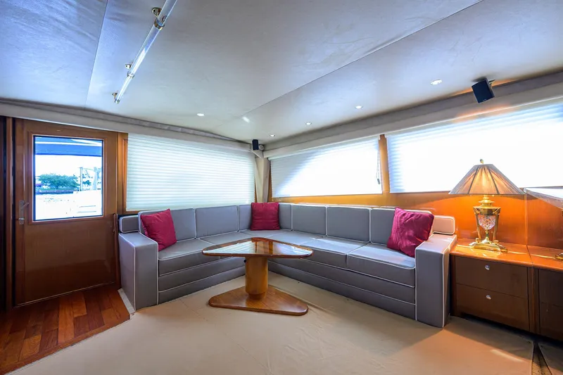  Yacht Photos Pics Interior of 2001 Viking 65 Enclosed Bridge yacht with modern seating and wooden table.