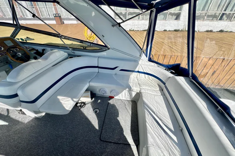  Yacht Photos Pics Interior of 2006 Formula 370 Super Sport boat with white seating and blue accents.