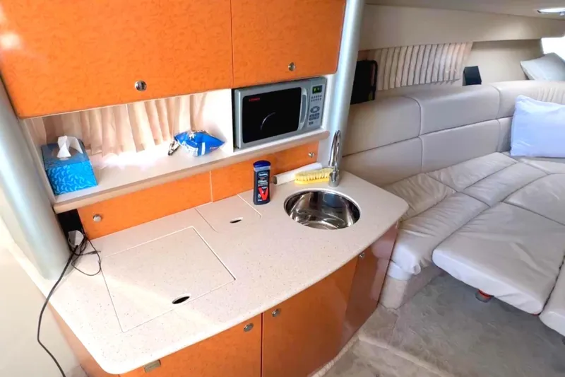  Yacht Photos Pics 2006 Formula 370 Super Sport interior with kitchenette, sink, microwave, and seating area.