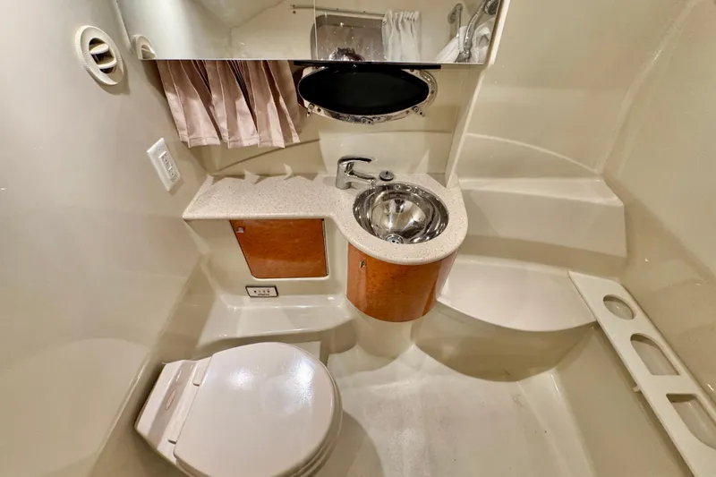  Yacht Photos Pics 2006 Formula 370 Super Sport boat bathroom with sink, toilet, and mirror.