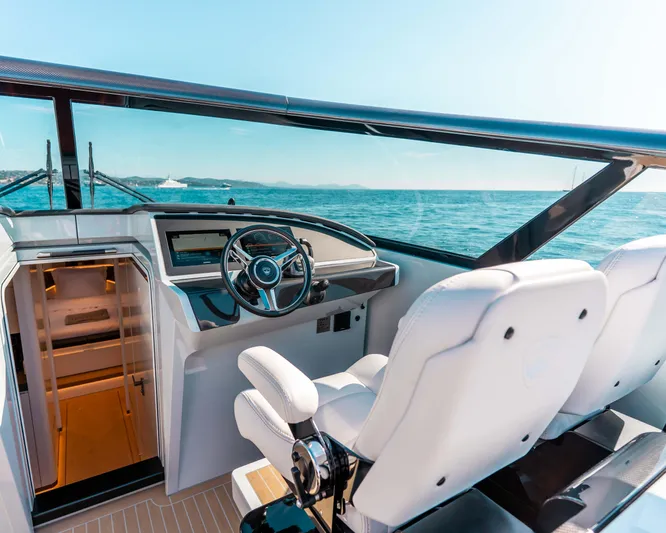 Greenwich Yacht Photos Pics Luxury Wajer 55 yacht cockpit with modern steering, ocean view, and sleek interior, 2022 model.