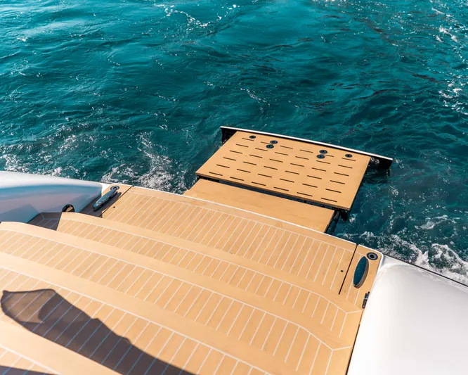 Greenwich Yacht Photos Pics Wajer 55 yacht's teak swim platform on blue ocean water, 2022 model.