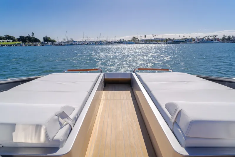 Mrs. Nicely Yacht Photos Pics Luxurious 2020 Riva Dolceriva yacht with sunbeds overlooking serene water and marina.