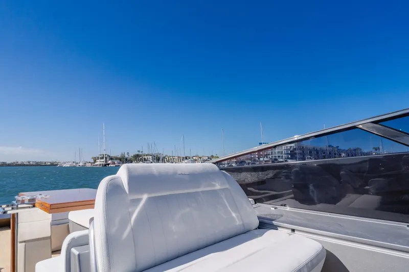 Mrs. Nicely Yacht Photos Pics Riva Dolceriva 2020 yacht with white seating, clear blue sky, and marina view.