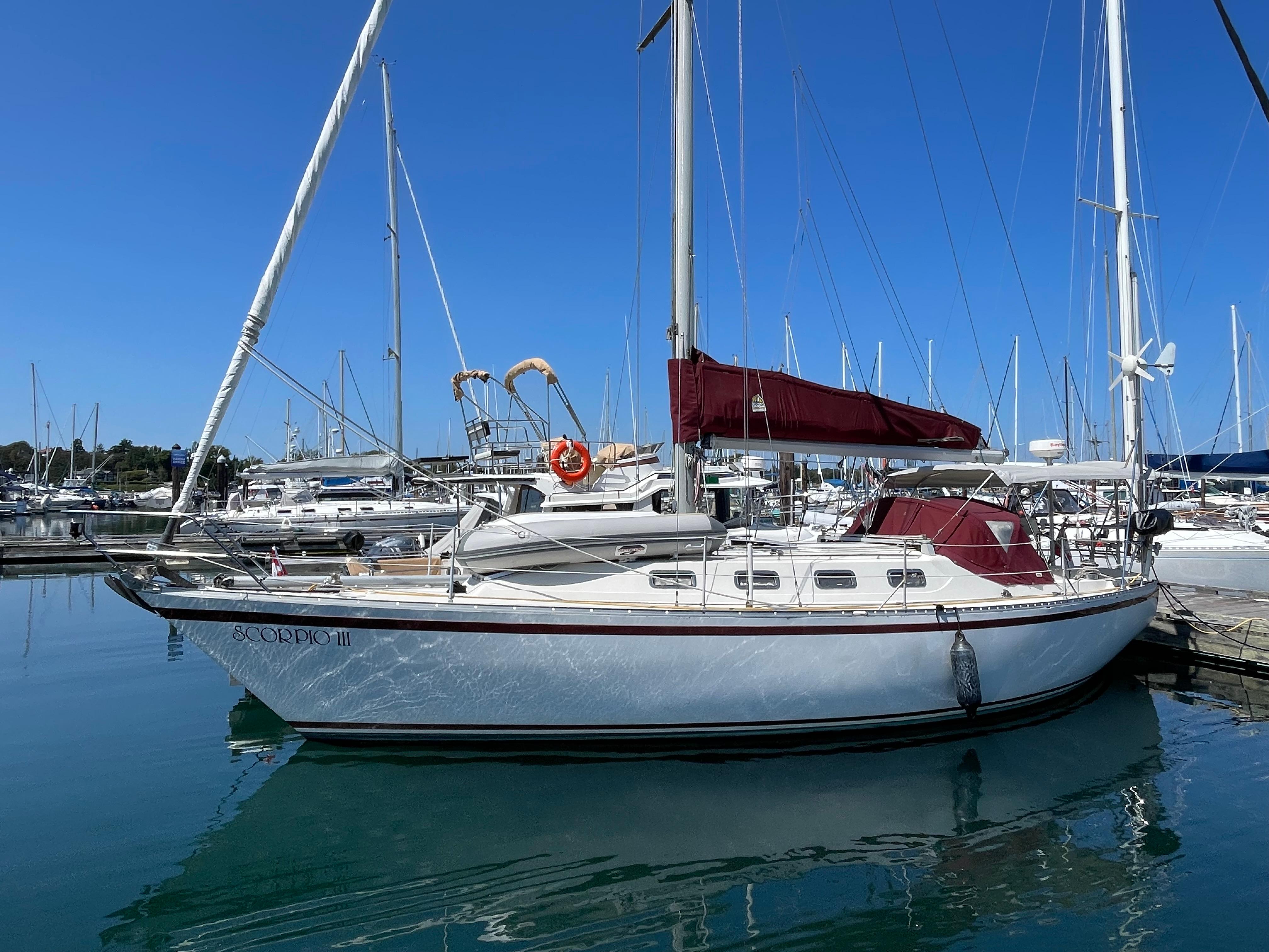 1980 CS 36 Traditional sailboat docked in a marina under clear blue skies.