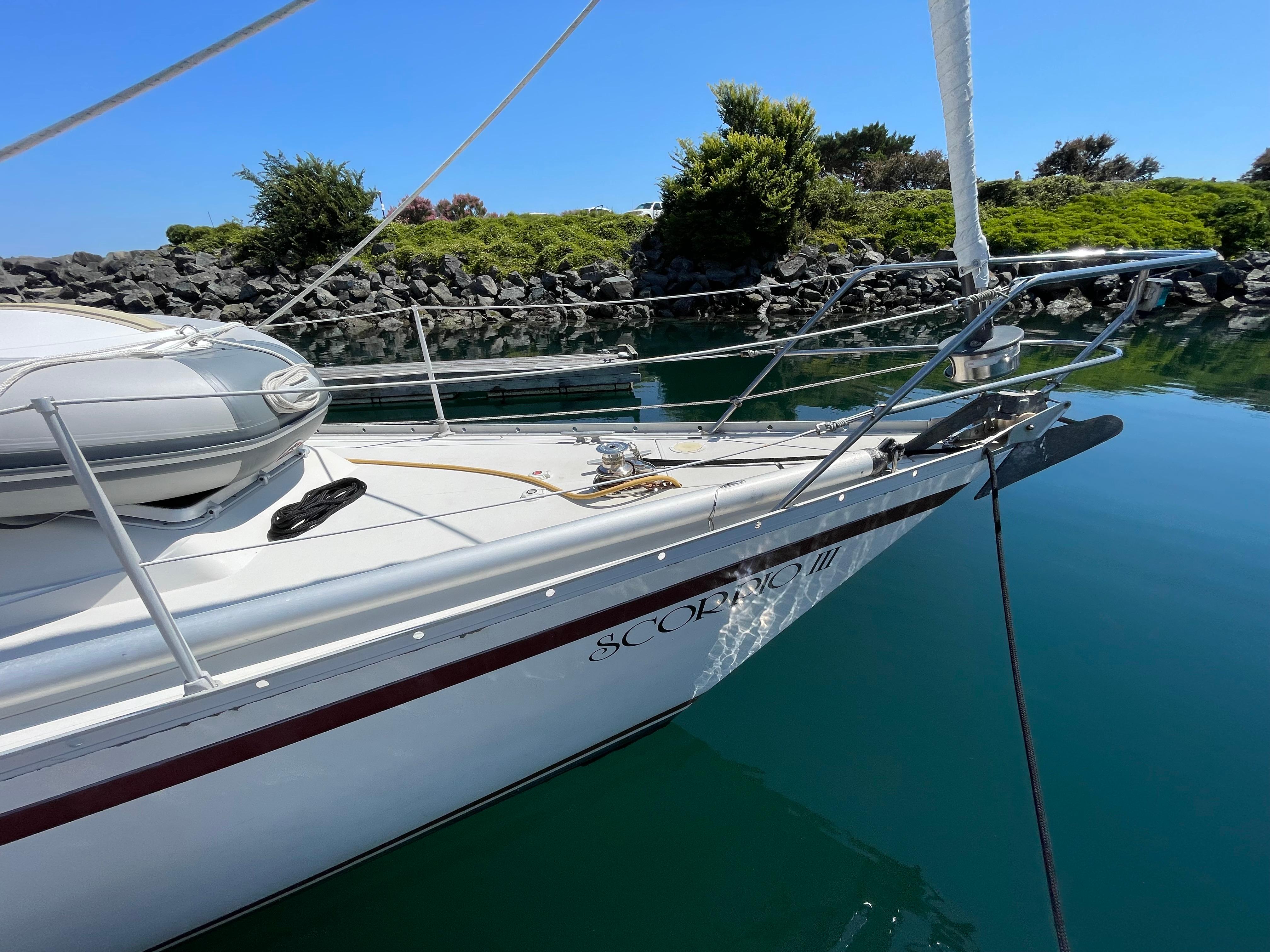 1980 CS 36 Traditional sailboat docked in calm waters, clear blue sky.