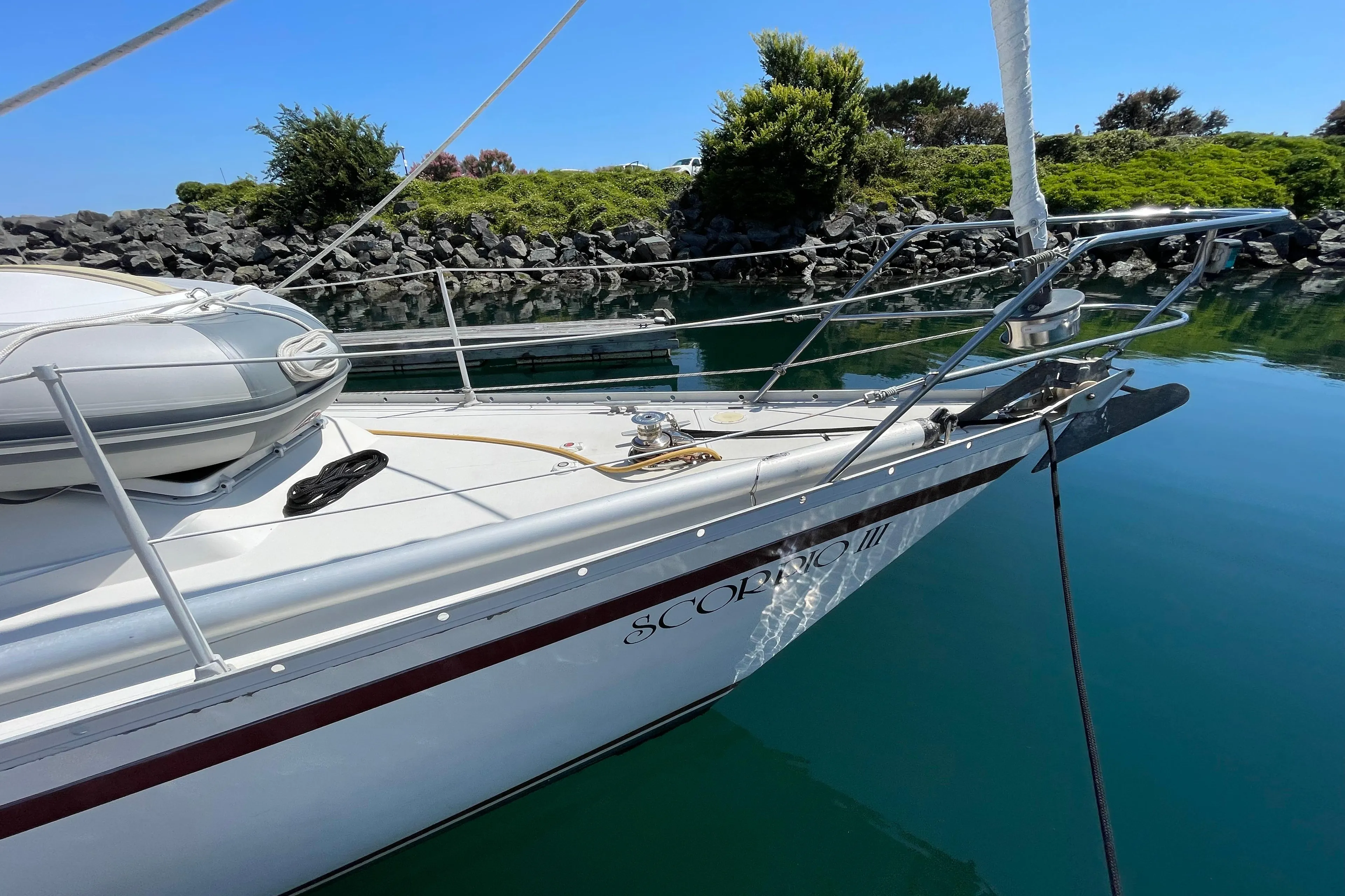 1980 CS 36 Traditional sailboat docked in calm waters, clear blue sky.