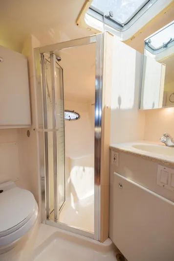 Mar's Bar Yacht Photos Pics 2000 Tiara Yachts Open model bathroom with shower, toilet, and sink.