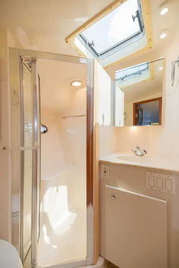 Mar's Bar Yacht Photos Pics 2000 Tiara Yachts Open model bathroom with shower, sink, and skylight.