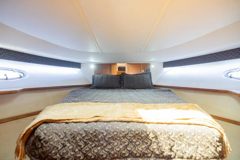 Mar's Bar Yacht Photos Pics Luxurious bedroom interior of 2000 Tiara Yachts Open model with cozy bedding.