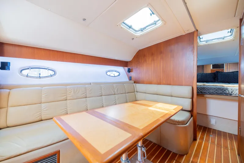 Mar's Bar Yacht Photos Pics Interior of 2000 Tiara Yachts Open model with leather seating and wooden table.